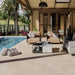 Outdoor patio area with furniture and pool in a residential setting