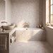 Bohemian Sand mosaic bathroom image with mosaic tiled bath and stone basin. 