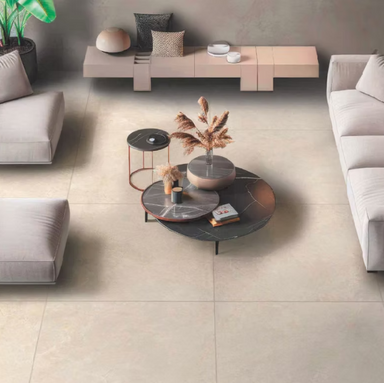 Modern living room with gray sofas and a coffee table on a tiled floor.